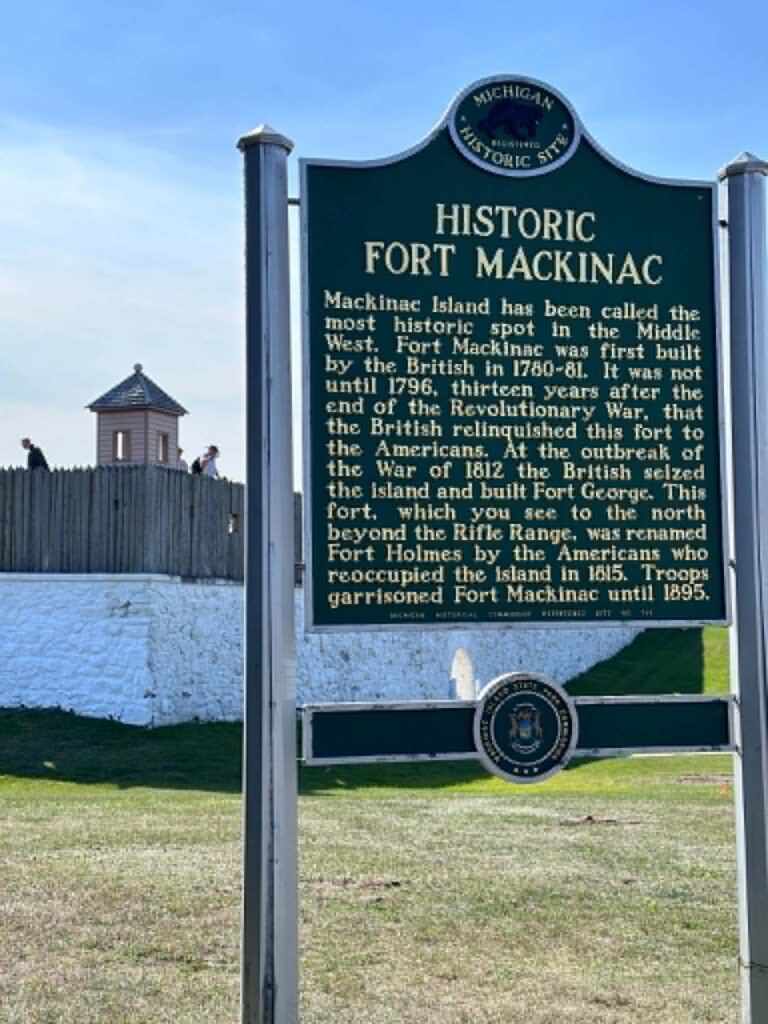 The whitewashed walls and blockhouse of Historic Fort Mackinac under a clear autumn sky