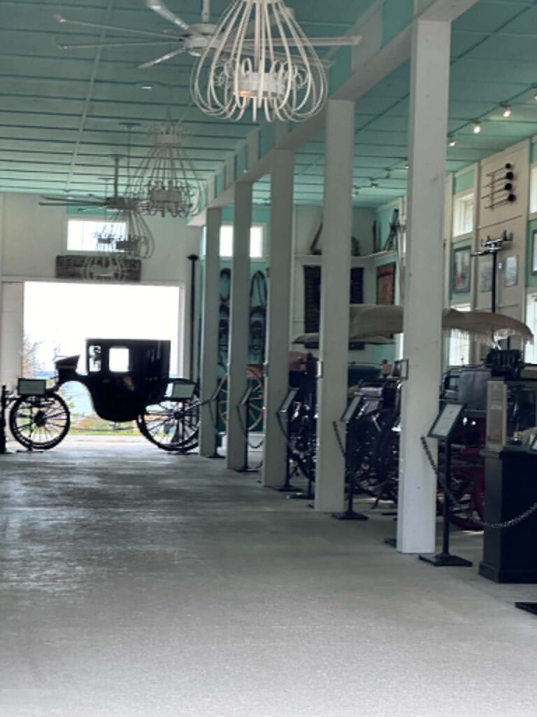 Antique carriages on display inside the Grand Hotel Stables on Mackinac Island