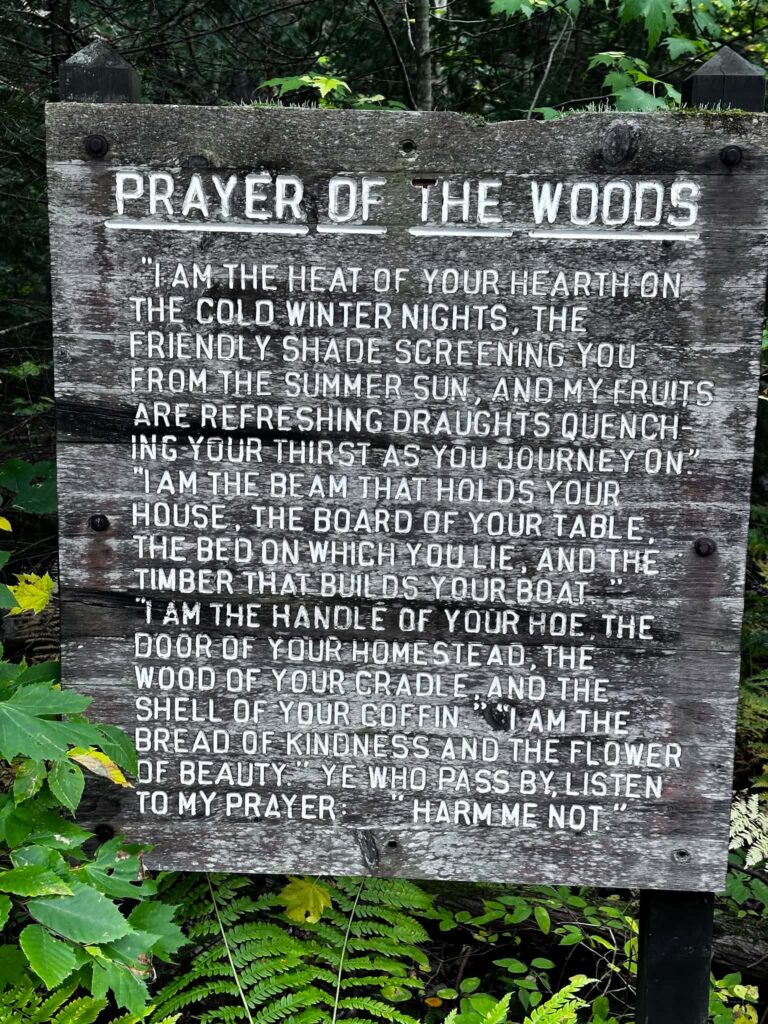 The Prayer of the Woods wooden plaque mounted on a post near the Lower Tahquamenon Falls trailhead