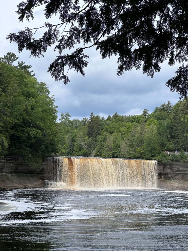 Distant scenic view of Upper Tahquamenon Falls surrounded by Upper Peninsula forest