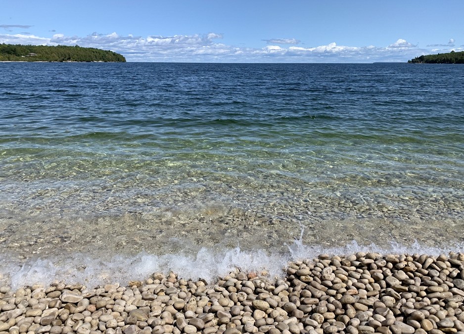 Schoolhouse Beach, Washington Island — the limestone bottom stays visible well out from shore, which is exactly what “clear” should mean.