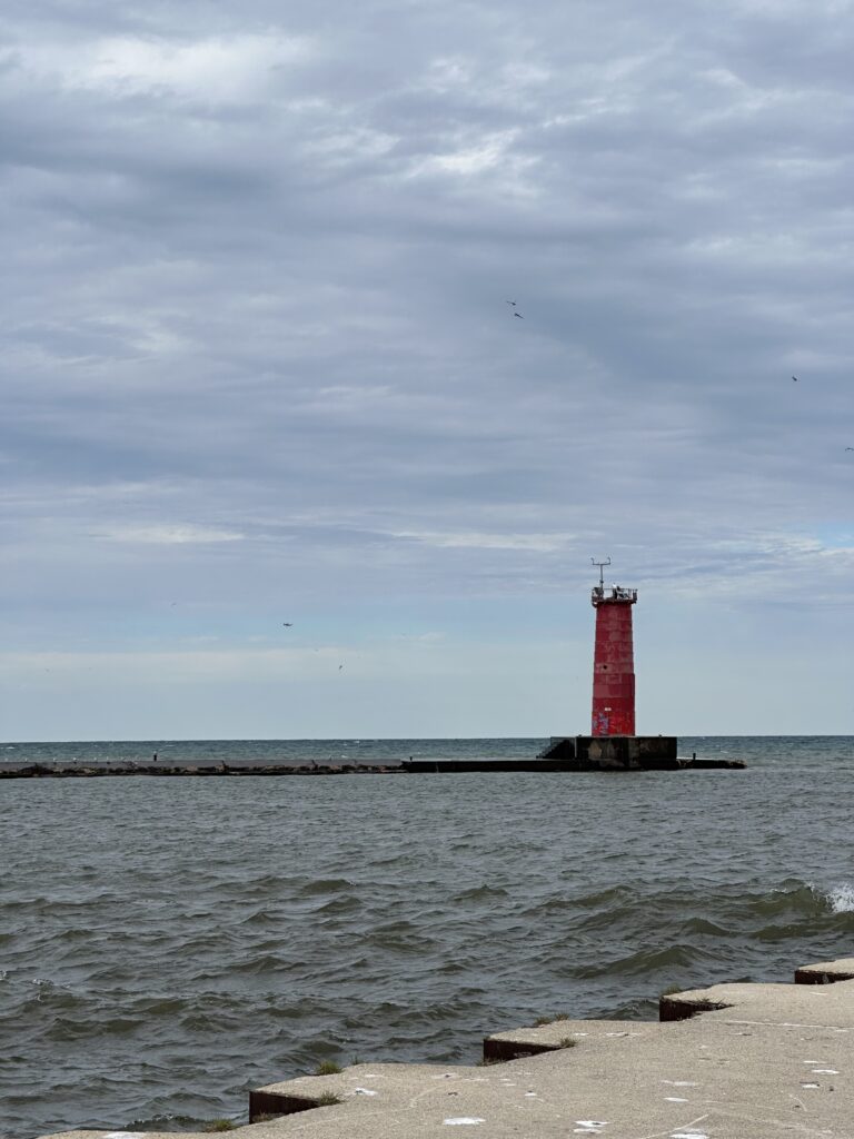 Sheboygan's Lake Michigan lighthouse on a windy day — the city has developed a genuine surf culture, and this is why.