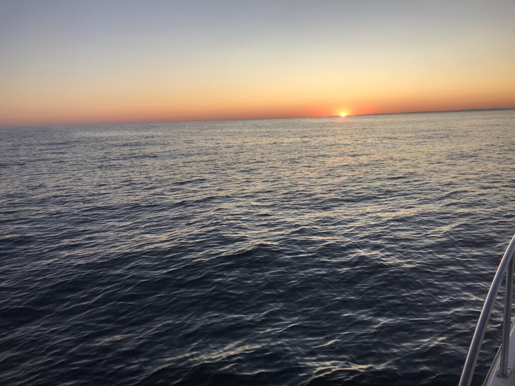 Sunset over Lake Michigan from the SS Badger ferry deck — four hours of open water between Ludington and Manitowoc, with nothing but the lake in every direction.