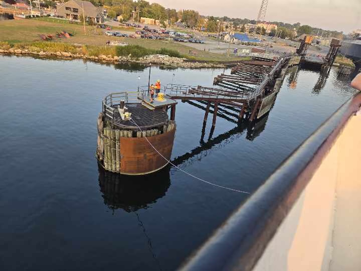 The SS Badger arriving at Ludington — shot from the ferry deck as the dock crew brings her in at golden hour. This is the crossing no competitor tells you about.