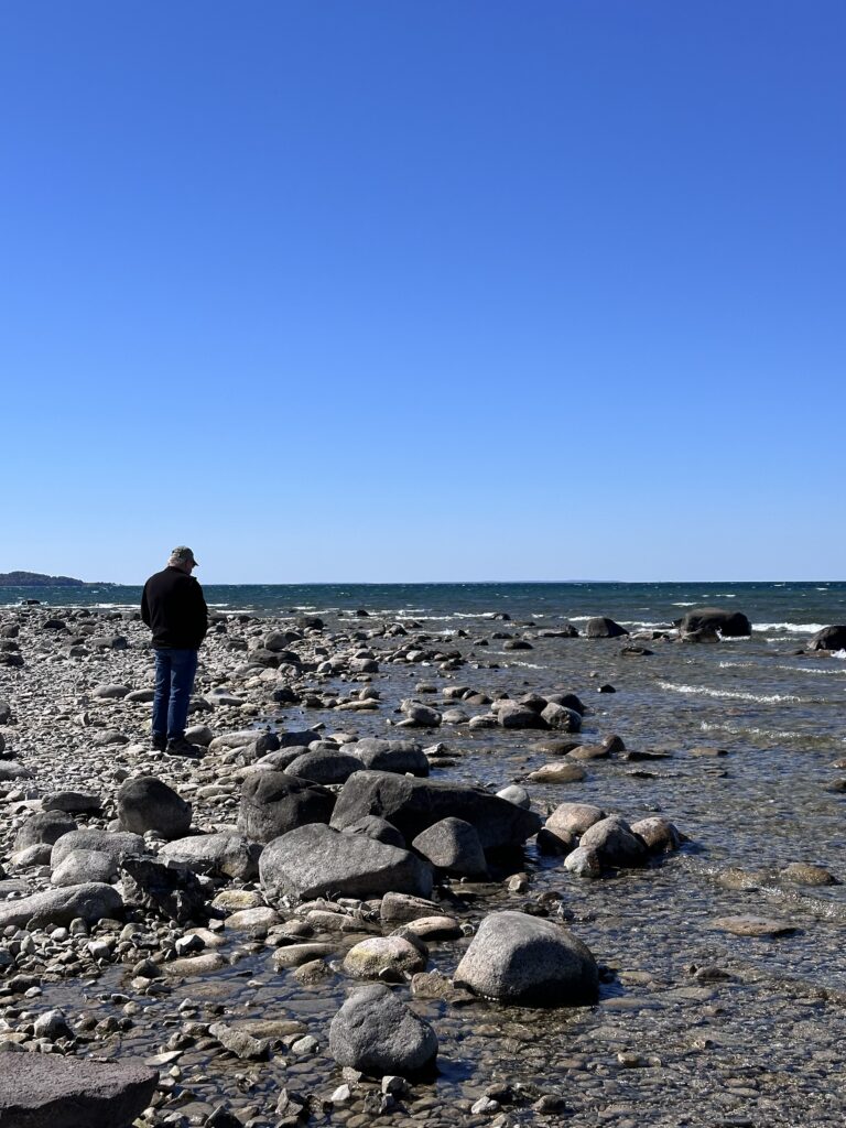 Rocky Lake Michigan shoreline at Grand Traverse Lighthouse, Leelanau Peninsula — the tip of the peninsula where the lake meets the bay