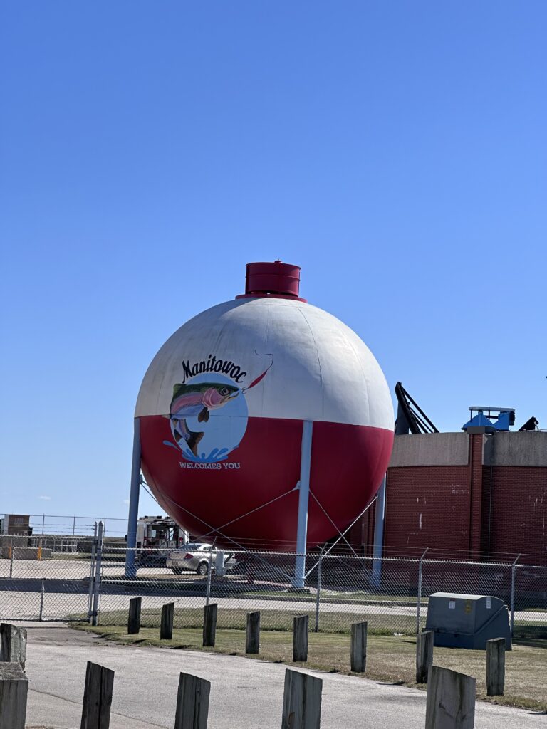 Manitowoc Wisconsin giant fishing bobber welcome landmark at SS Badger ferry dock with leaping trout painting