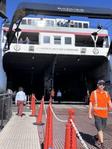 SS Badger Ludington National Historic Landmark stern with passengers disembarking gangway and crew at Manitowoc Wisconsin dock