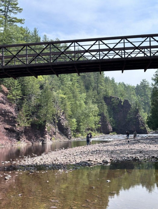 Footbridge over the Bad River near exposed volcanic rock outcrops