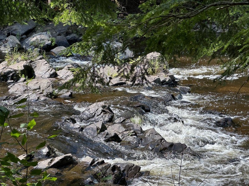 Rocky cascades tumbling through hemlock forest along the Bad River
