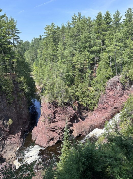 Twin waterfalls dropping into the red rock gorge at Copper Falls